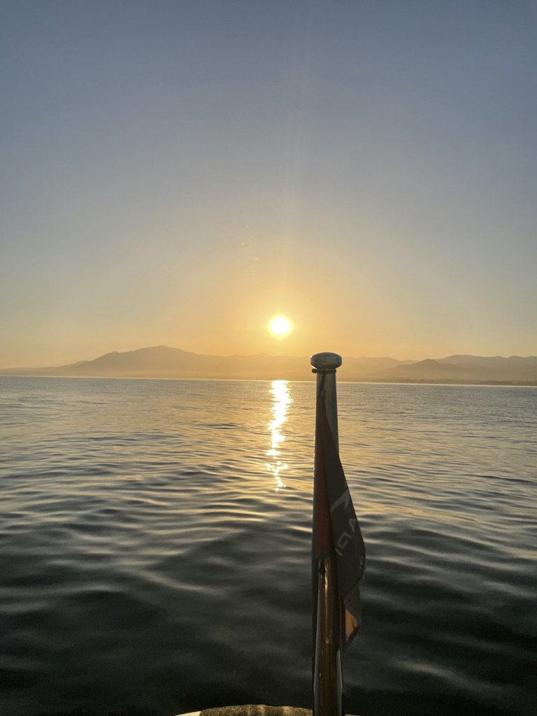 Sunrise over the sea and the mountains from a boat off Marbella