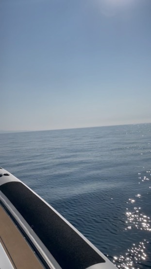 Flat calm Mediterranean seen from the side of a boat