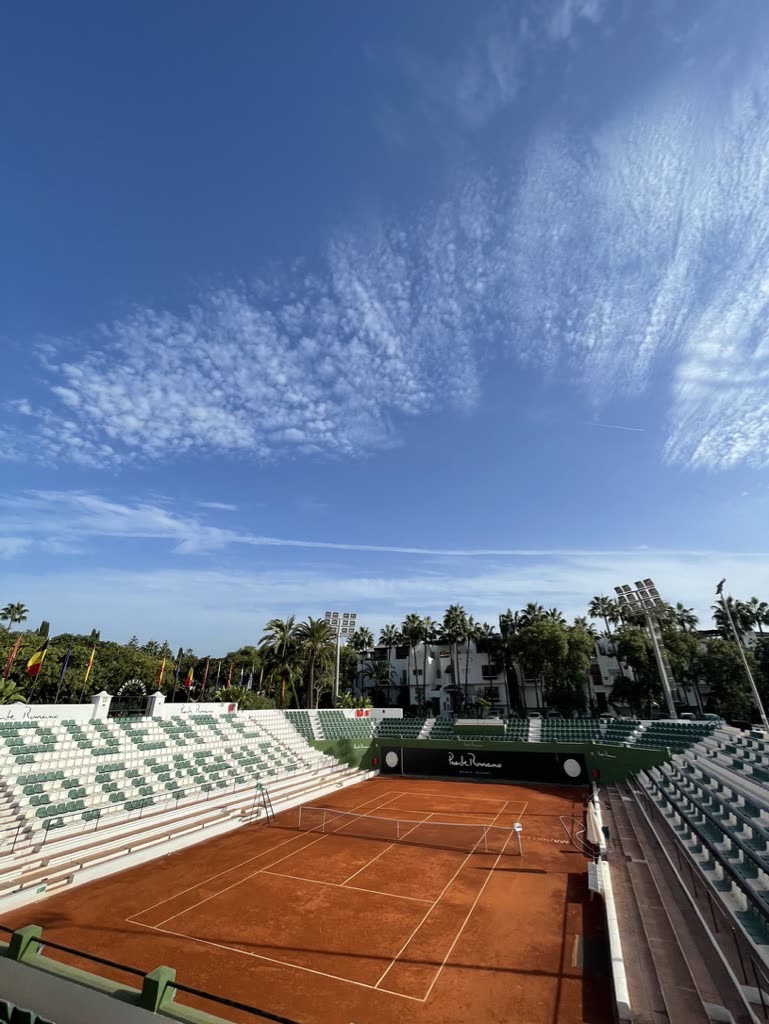 Empty clay tennis court at Puente Romano, Marbella